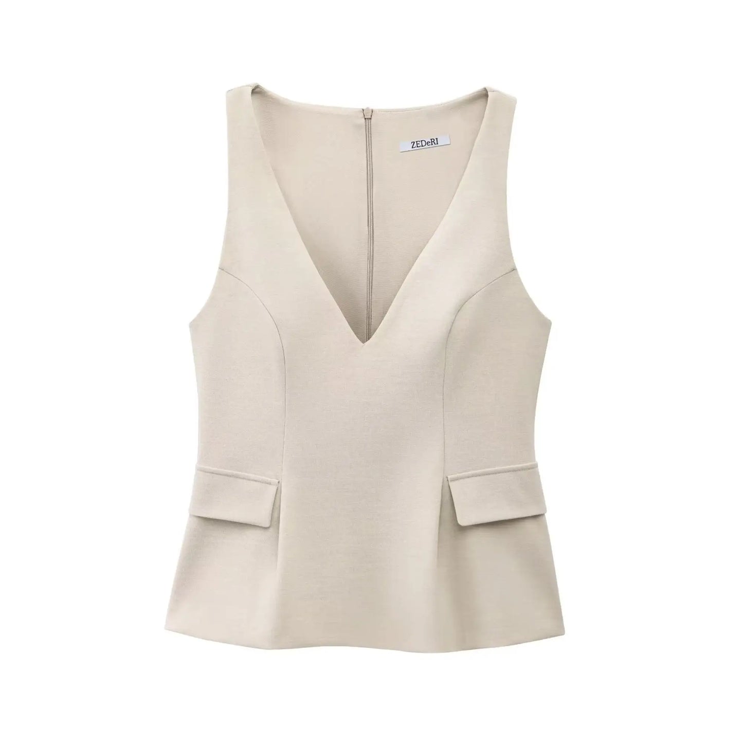 Top peplum beige en tissu stretch, cintré à la taille pour une silhouette féminine.