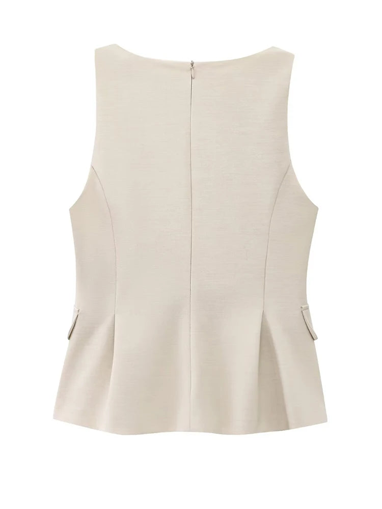 Top peplum beige en tissu stretch, cintré à la taille pour une silhouette féminine.