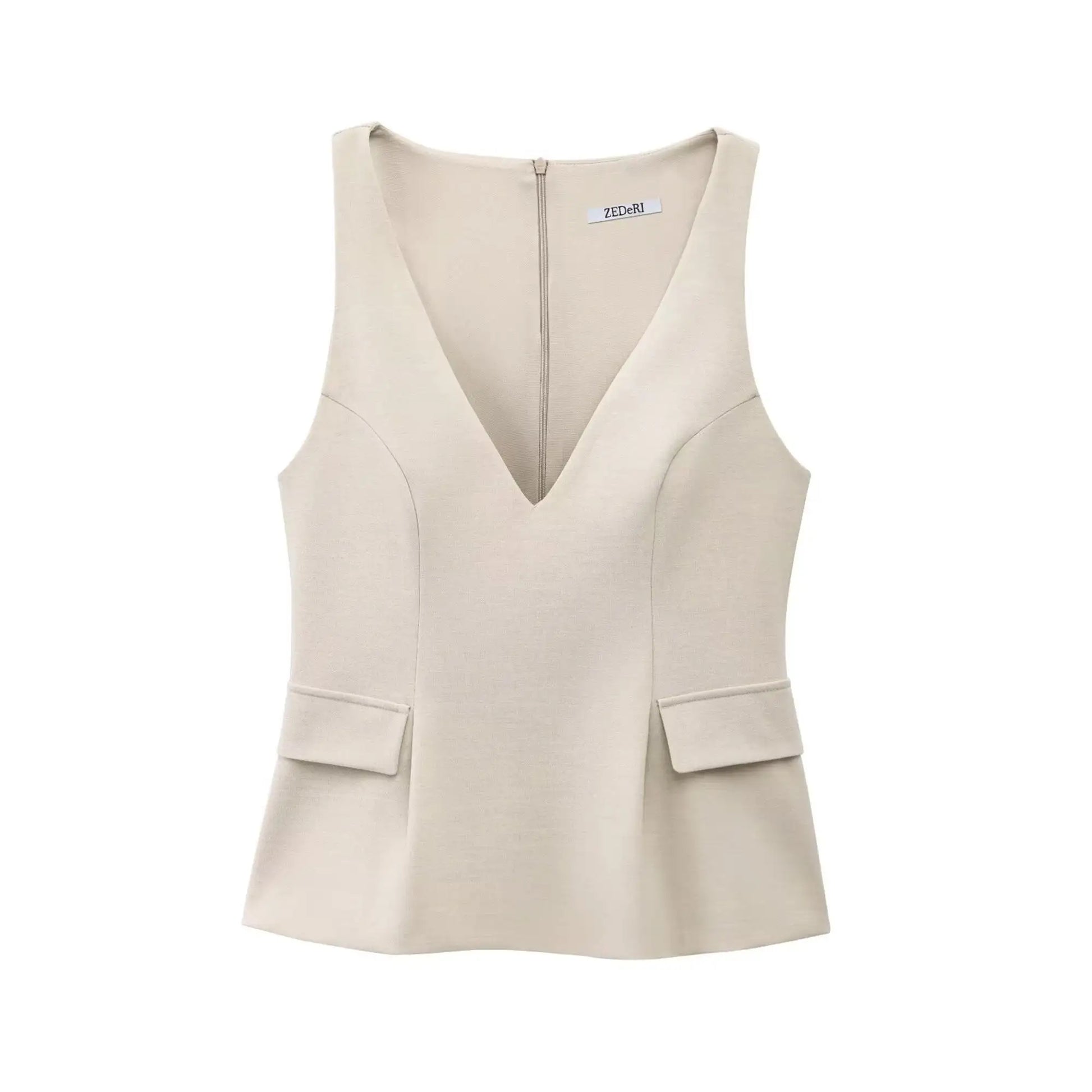 Top peplum beige en tissu stretch, cintré à la taille pour une silhouette féminine.